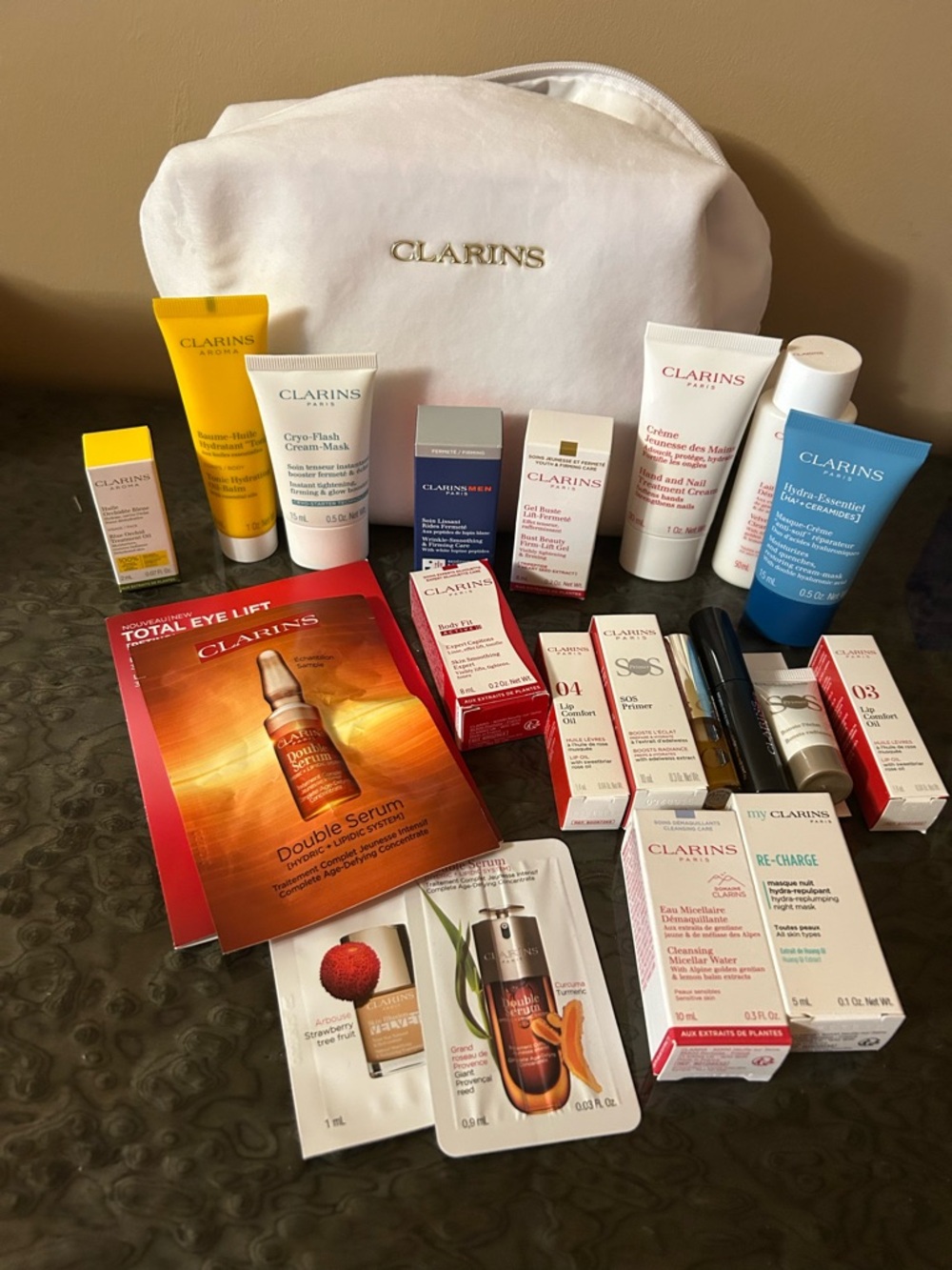 Clarins Travel Pouch with White, Yellow, Blue & Red Skincare Sampler